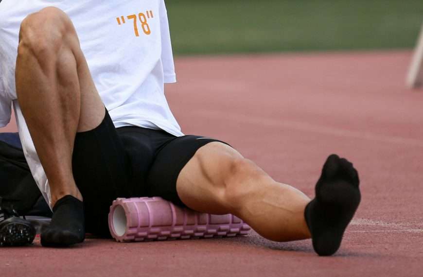 Person using foam roller for muscle recovery and to treat DOMS after intense workout