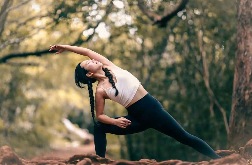 Yoga vs flexibility training comparison showing woman performing deep stretch on mat demonstrating range of motion