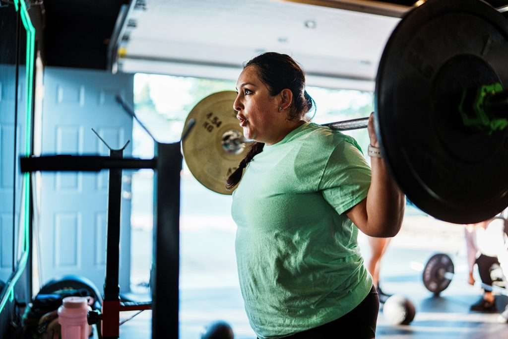 Person practicing body-neutral fitness goals with functional training.