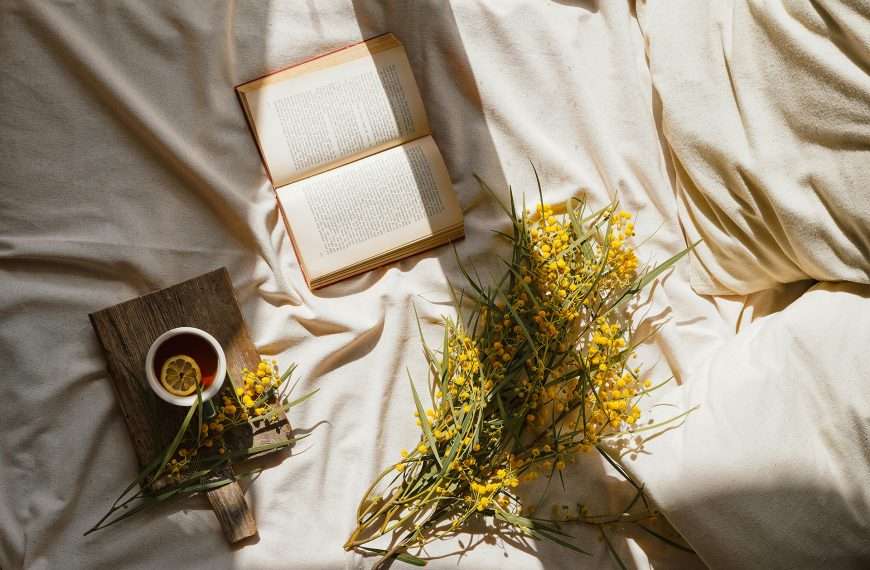 Relaxing bedtime setup with gentle lighting and book on bed, perfect for winding down with stretches before bed