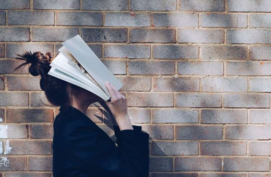 A stressed woman holds papers over her face, a reminder that breathwork alone may not be enough to calm your nervous system.